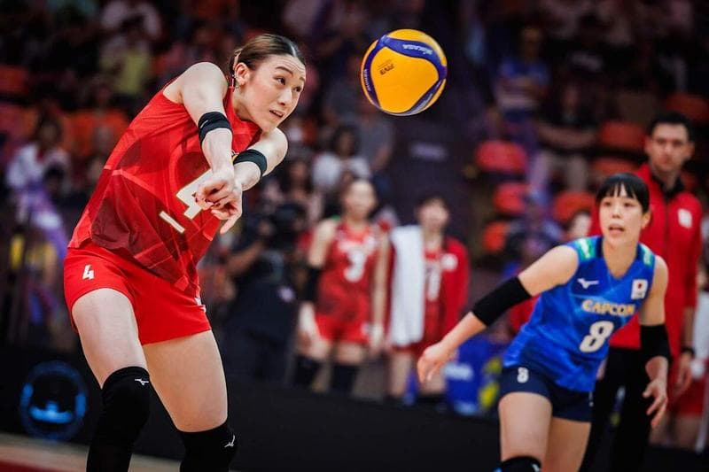 Women's volleyball player passing a ball during an indoor match